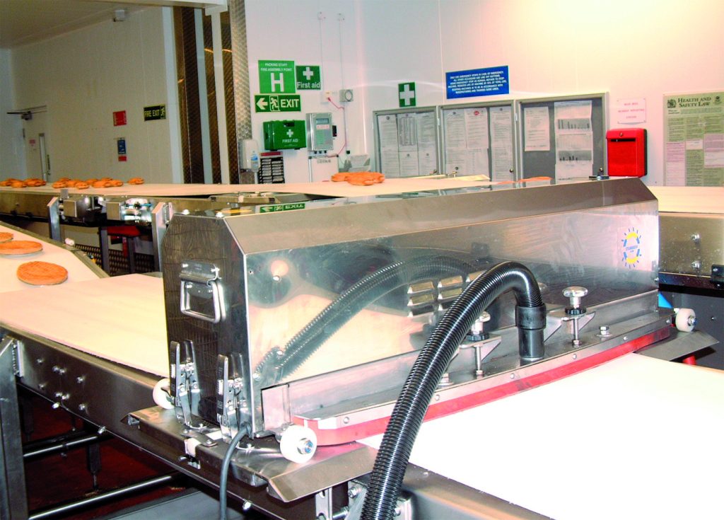 Conveyor Belt in a Food Processing Facility being cleaned by Duplex Cleaning Machines