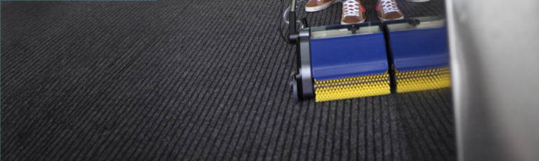 The Duplex Lihuum machine is cleaning a carpet floor.
