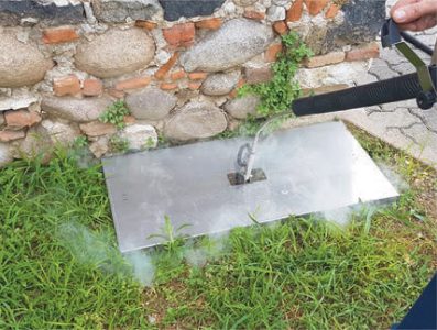 Image depicting steam weed control technology being used on roadsides and pathways, illustrating a safe, eco-friendly weed management solution.