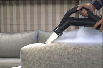 Image depicting the use of Duplex's steam cleaning and vacuuming solutions for upholstery in caravan park accommodations.