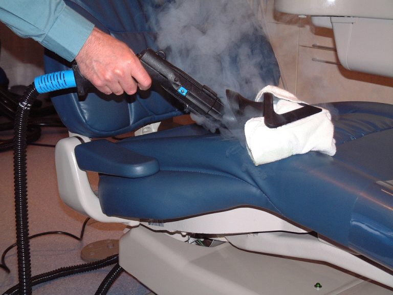 Image depicting the specialised cleaning process of a dental chair in a clinic, focusing on hygiene and patient comfort.
