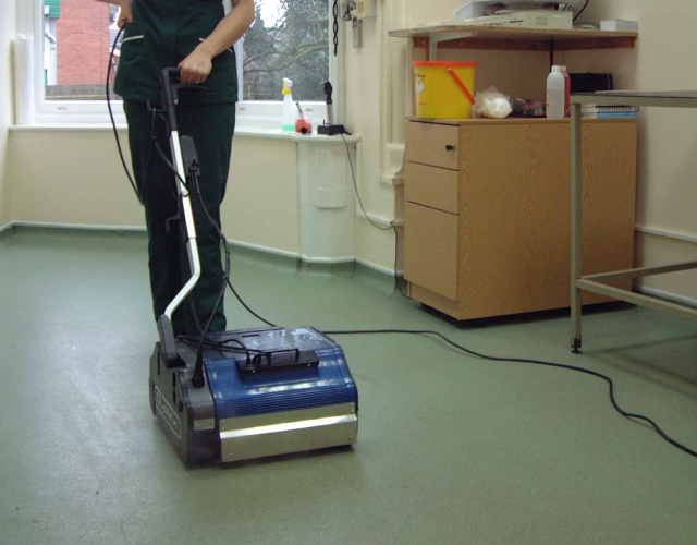 Image showing the rapid cleaning process of hard floor areas, like corridors, in a hospital, highlighting efficiency and thoroughness.