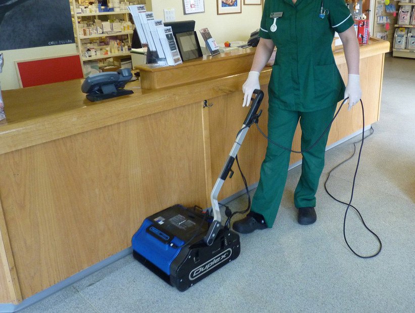 Image showing the meticulous cleaning of a waiting room in a medical centre, ensuring a hygienic and inviting space for patients.