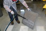 Image depicting the restoration process of cooling fins and coils in an air conditioner, using advanced cleaning technology for effective dust and stain removal.