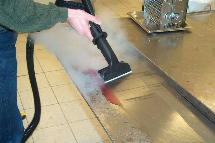 Photograph depicting the cleaning of stainless steel surfaces in a food and beverage manufacturing facility using advanced cleaning technology.