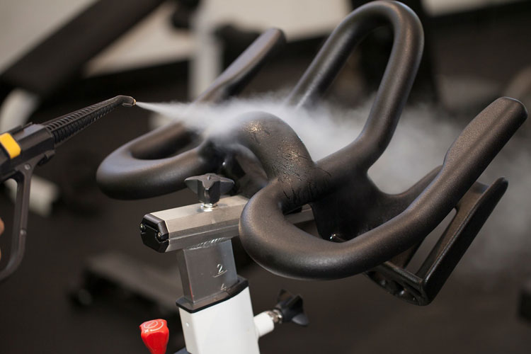 Image showcasing Duplex Cleaning Machines' steam cleaning technology for sanitising, disinfecting, and deep cleaning exercise bicycles in gym and fitness club environments.