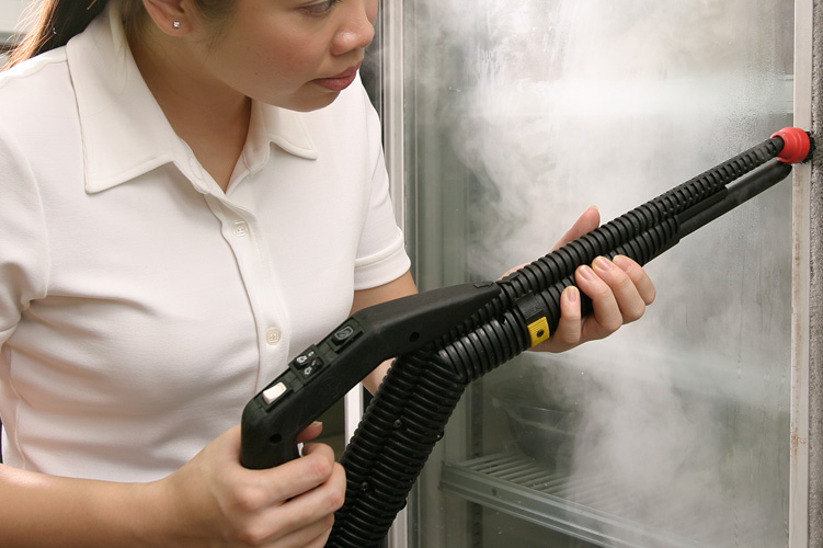Image showcasing the use of steam cleaning technology for sanitising and deodorising fridge doors and storage areas in an ice cream production facility, without harsh chemicals.
