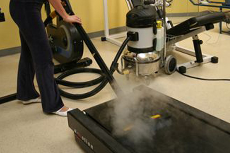 Image displaying the effective steam and vacuum cleaning of treadmills in sports and fitness centres using Duplex Cleaning Machines.