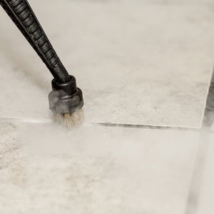 An image showing Duplex's steam cleaning machines effectively cleansing and rejuvenating grout lines in a bathroom.