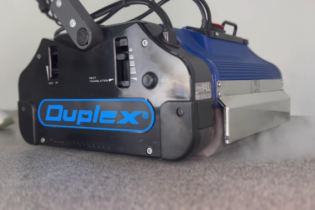 Duplex floor cleaning machine using steam to clean a vinyl surface, ideal for commercial cleaning applications