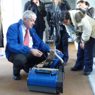 Technician demonstrating service and parts support for Duplex floor cleaning machine