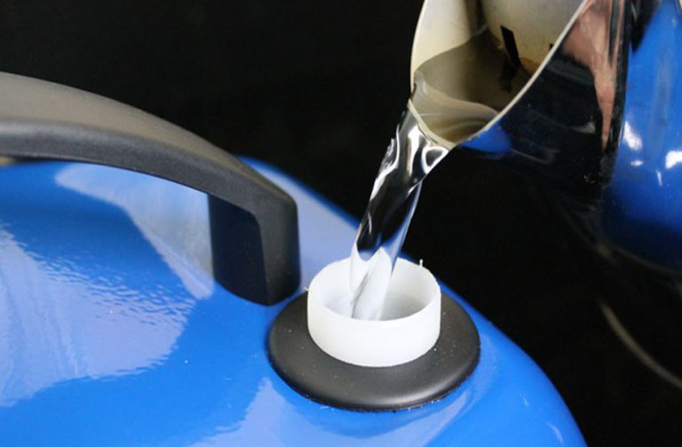 Pouring water into a steam cleaner tank, highlighting minimal water usage design.