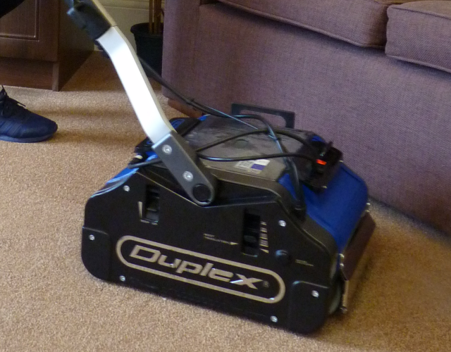 Using a Duplex machine to deep clean carpets and remove spills in a retirement village lounge area.