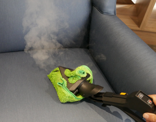 Steam cleaning a fabric chair in a retirement village to ensure hygiene and resident comfort.