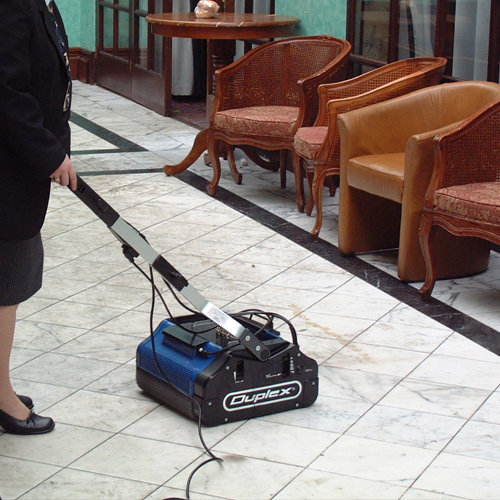Duplex 420 floor cleaning machine being used on polished hard surface in a public lounge area