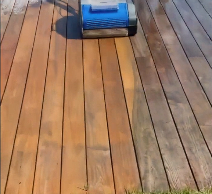 Duplex 420 floor scrubbing machine cleaning a weathered timber deck with clear before and after results