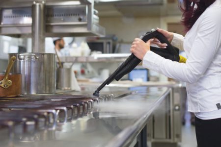 Steam cleaning commercial kitchen cooking surfaces and equipment