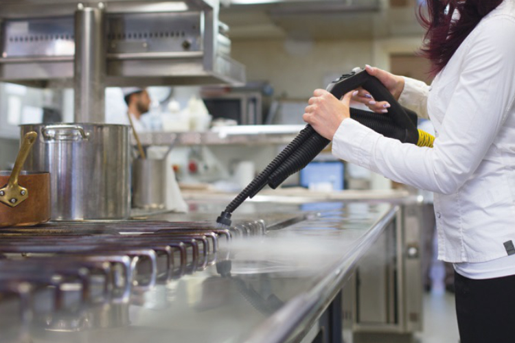 Steam cleaning commercial kitchen cooking surfaces and equipment